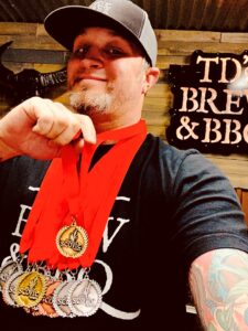 TD's brew and BBQ employee showing their awards
