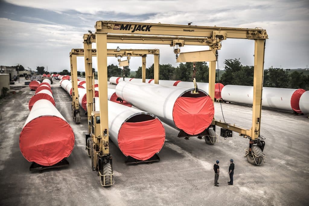 Crane holding wind tower poles