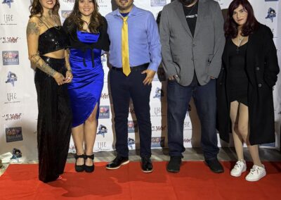 5 members of Invisible Hand Entertainment stand on the red carpet