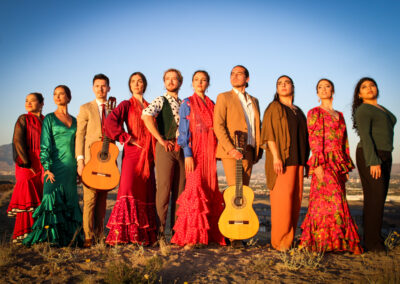 The members of Spanish Broom pose in traditional clothing outdoors